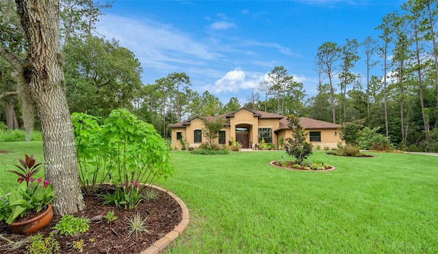 mediterranean / spanish home featuring a front yard