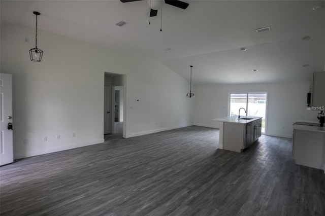 unfurnished living room with dark hardwood / wood-style flooring, high vaulted ceiling, ceiling fan, and sink