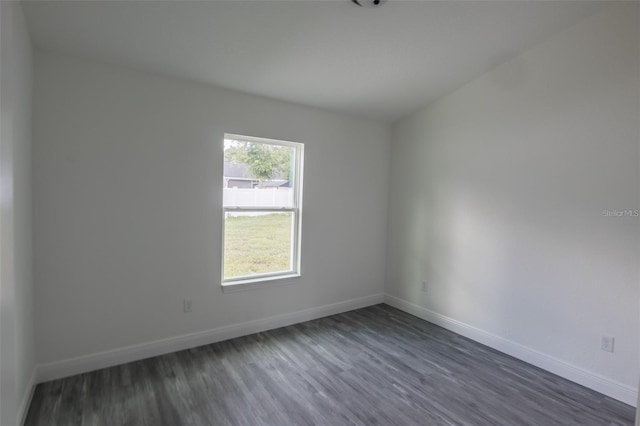 spare room featuring dark wood-type flooring