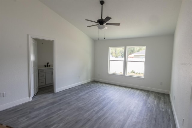 unfurnished room featuring ceiling fan, dark hardwood / wood-style flooring, vaulted ceiling, and sink