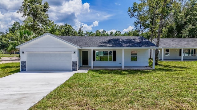 single story home featuring a porch, a garage, and a front yard