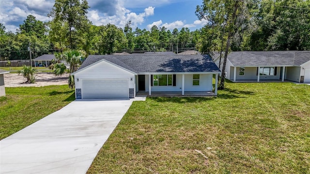 ranch-style home with covered porch, a garage, and a front lawn