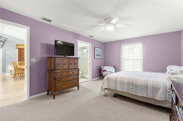 bedroom with connected bathroom, ceiling fan, light colored carpet, and a textured ceiling