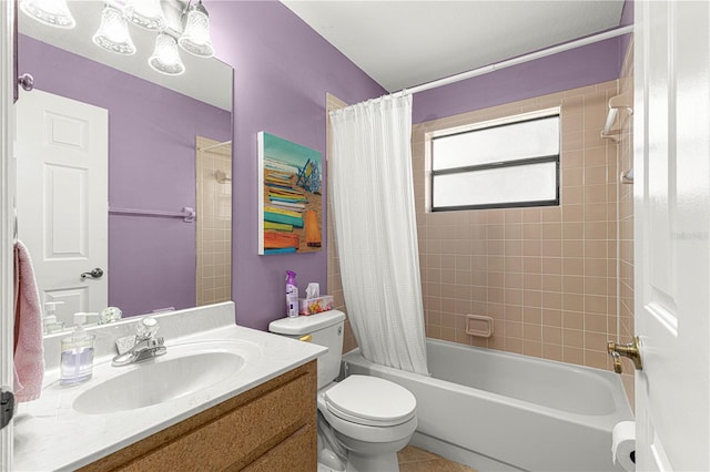 full bathroom with tile patterned floors, shower / bath combo with shower curtain, vanity, and toilet