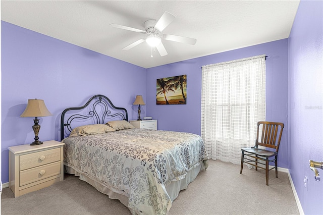 bedroom with ceiling fan and light carpet