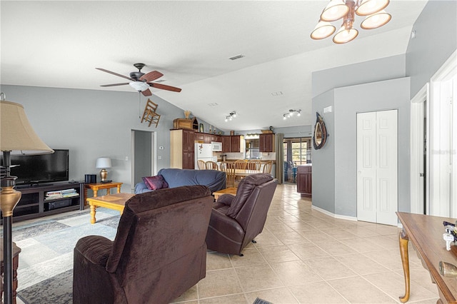 living room featuring ceiling fan with notable chandelier, vaulted ceiling, and light tile patterned flooring