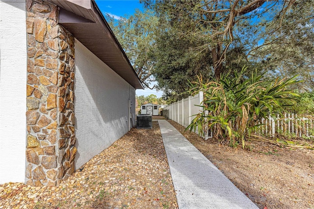 view of side of home with central AC