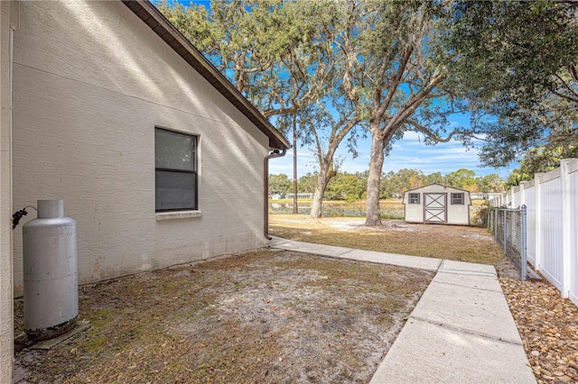 view of yard featuring a patio area and a storage shed