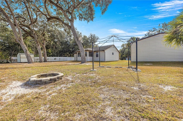 view of yard with an outdoor fire pit