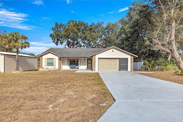 ranch-style home with covered porch, a garage, and a front lawn