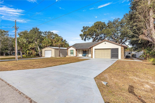 ranch-style house featuring a garage and a front lawn