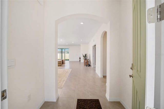 6071 SW 93rd Loop, Ocala, FL 34476 - hallway featuring arched walkways, light tile patterned floors, baseboards, and recessed lighting