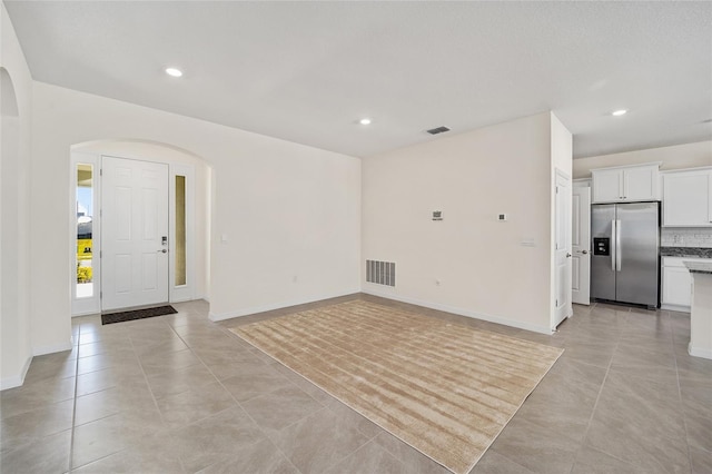 unfurnished living room with light tile patterned flooring