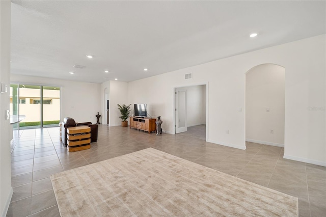 unfurnished living room with light tile patterned floors