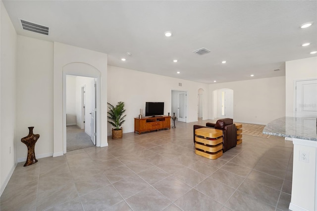 6071 SW 93rd Loop, Ocala, FL 34476 - living room featuring arched walkways, recessed lighting, light tile patterned floors, and baseboards