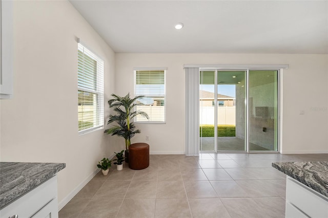 doorway with light tile patterned floors