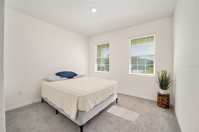 bedroom featuring light colored carpet