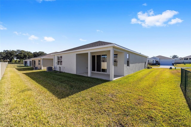 exterior space with central air condition unit, a lawn, and a patio