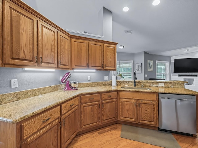 kitchen with kitchen peninsula, light stone countertops, sink, light hardwood / wood-style flooring, and dishwasher