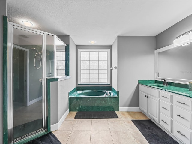 bathroom with tile patterned flooring, vanity, a textured ceiling, and independent shower and bath