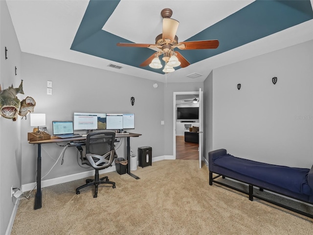 office space featuring ceiling fan and light carpet