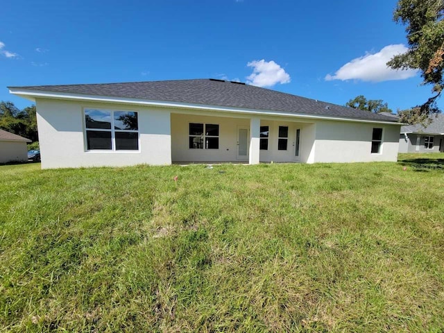 back of house featuring a yard