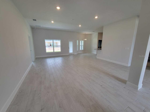8309 SW 58th Ave, Ocala, FL 34476 - unfurnished living room with light wood-style flooring and recessed lighting