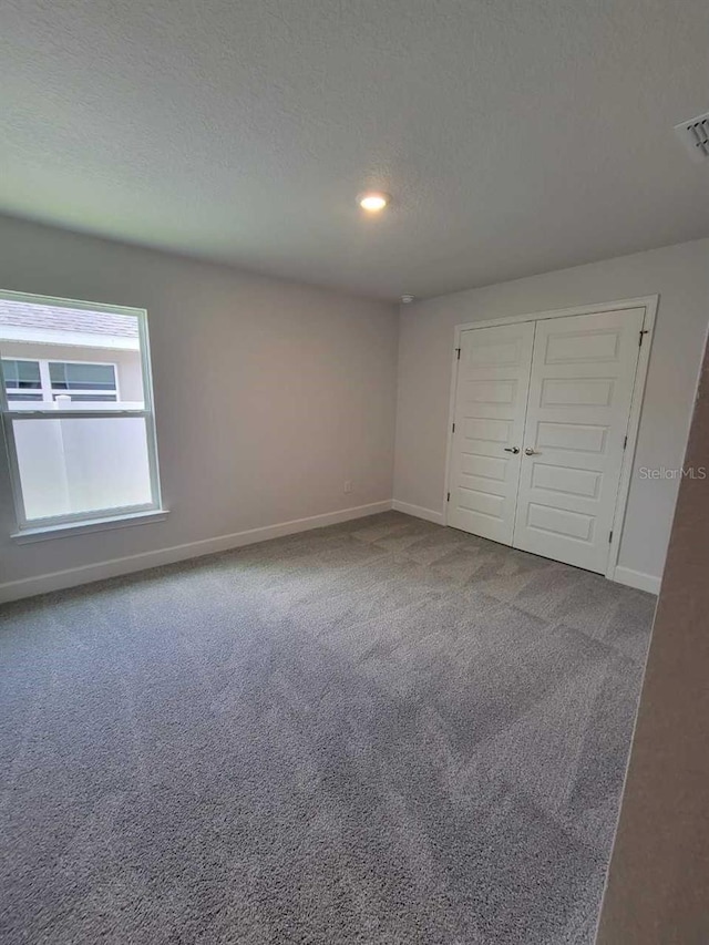 8309 SW 58th Ave, Ocala, FL 34476 - unfurnished bedroom with carpet, a textured ceiling, a closet, and recessed lighting