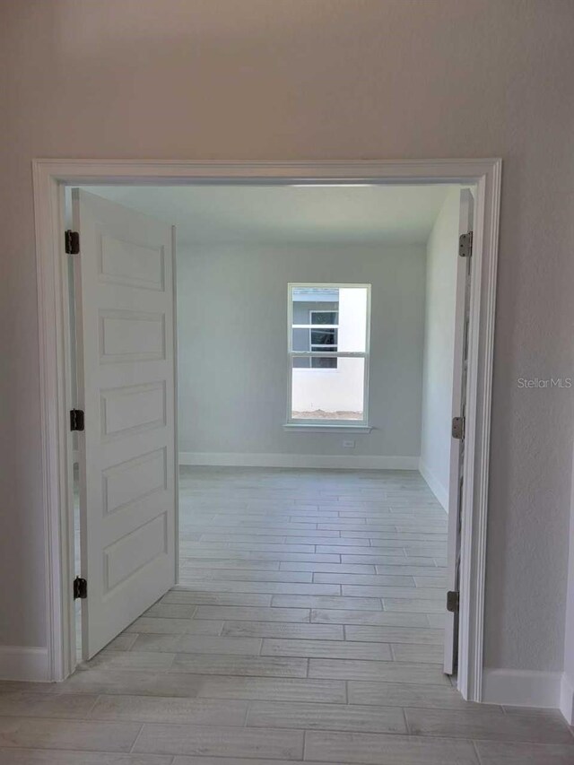8309 SW 58th Ave, Ocala, FL 34476 - hallway with light wood-style flooring and baseboards