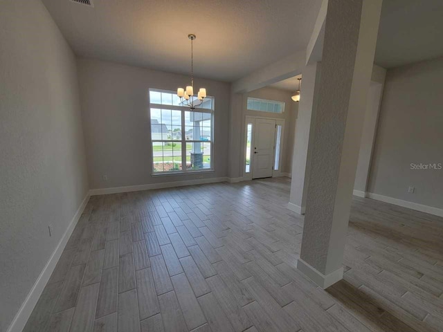 8309 SW 58th Ave, Ocala, FL 34476 - unfurnished room featuring wood finished floors and a chandelier