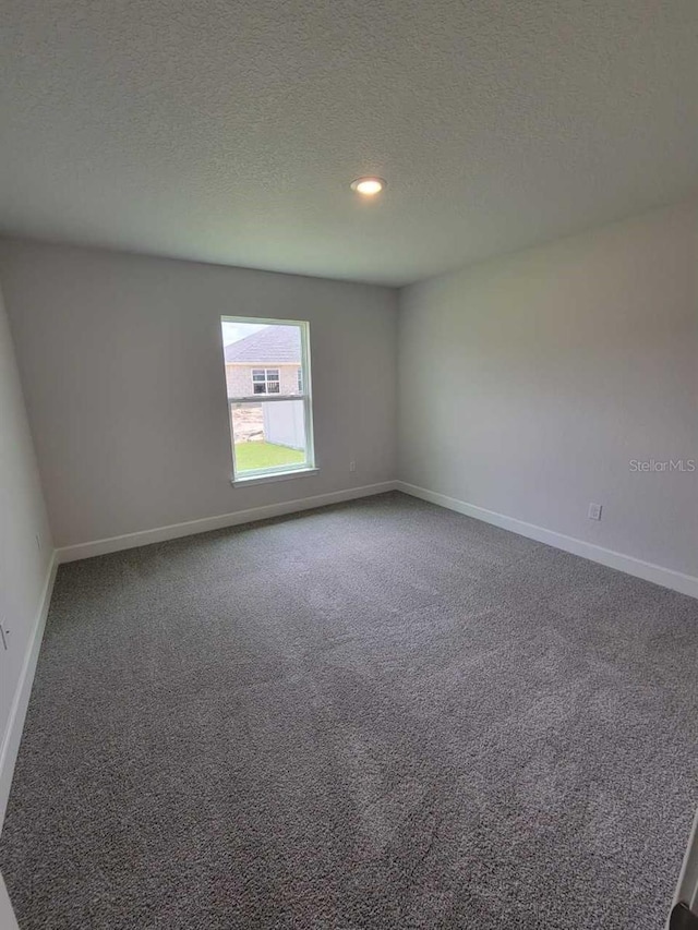 8309 SW 58th Ave, Ocala, FL 34476 - spare room featuring dark colored carpet, a textured ceiling, and recessed lighting