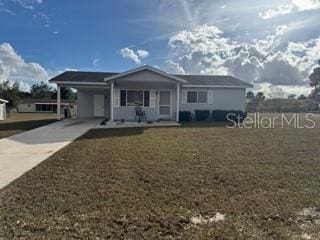 single story home with a carport, covered porch, and a front lawn