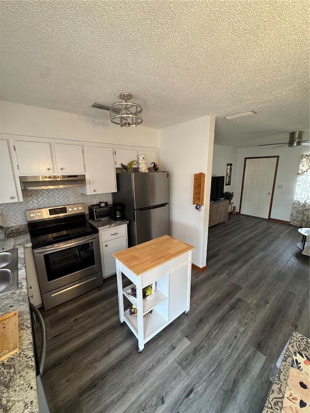 kitchen featuring dark wood-type flooring, ceiling fan, stainless steel appliances, light stone countertops, and white cabinets