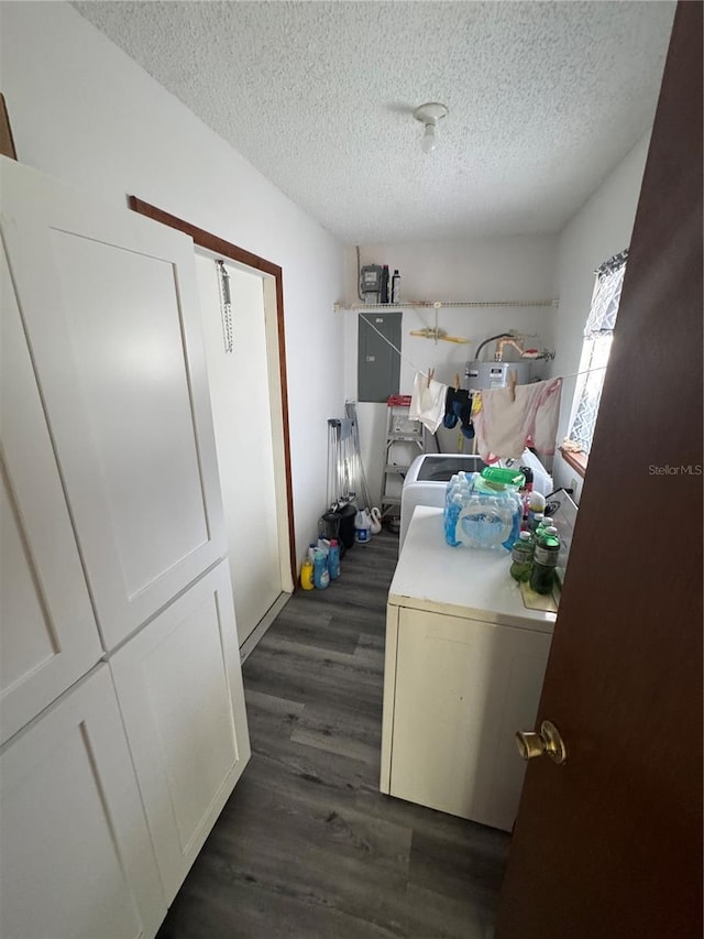 washroom featuring dark hardwood / wood-style flooring, a textured ceiling, and washer and clothes dryer