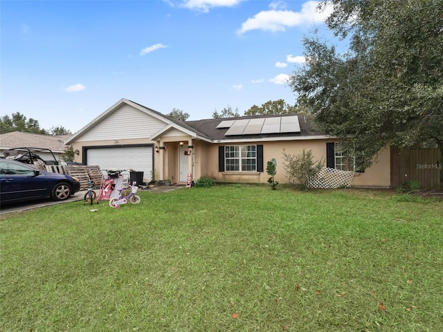 ranch-style home with solar panels, a garage, and a front yard