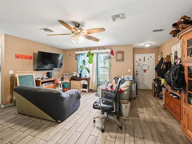 living room with light hardwood / wood-style flooring and ceiling fan