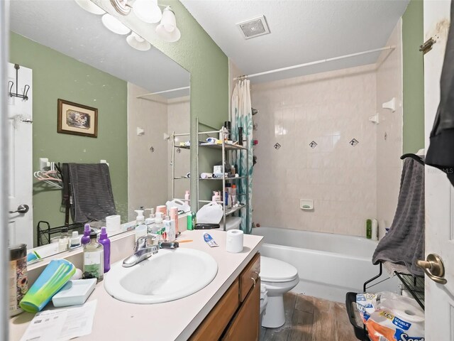 full bathroom with hardwood / wood-style floors, vanity, toilet, and shower / bath combo with shower curtain