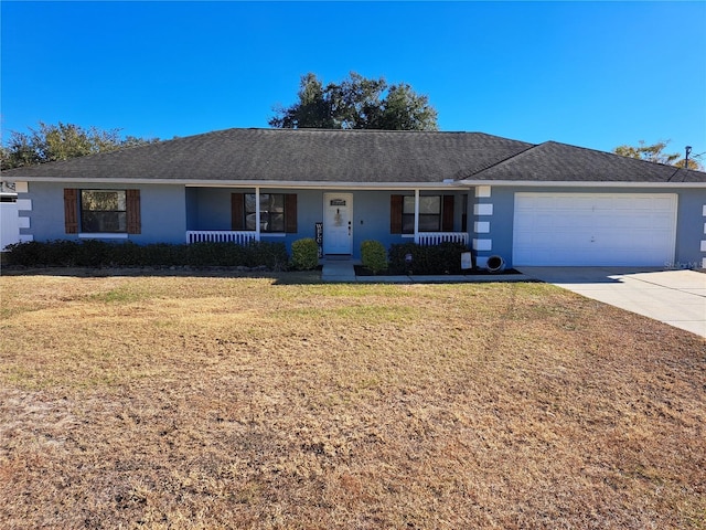 ranch-style house featuring a porch, a garage, and a front lawn