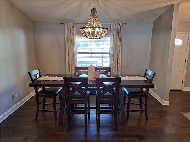 dining space with a chandelier and dark hardwood / wood-style floors