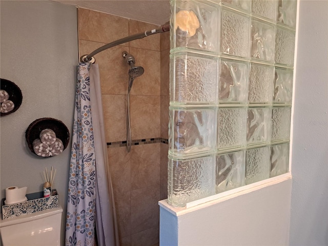 bathroom featuring curtained shower and toilet