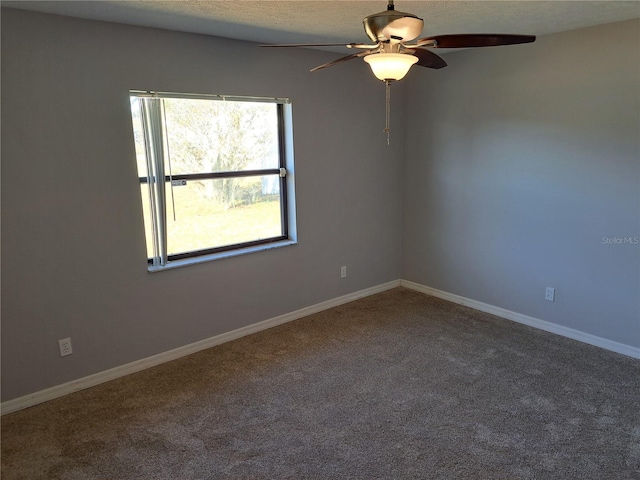 carpeted spare room featuring ceiling fan and a textured ceiling