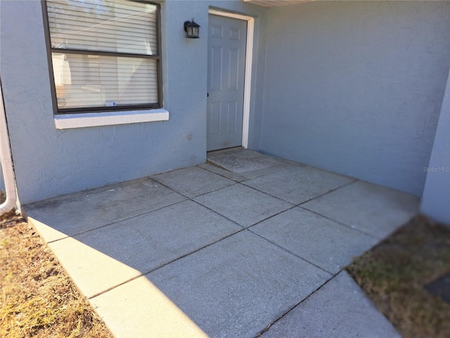 entrance to property with a patio area