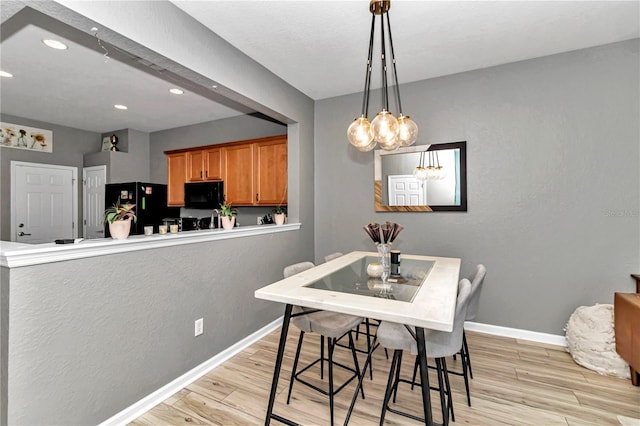 dining room with light hardwood / wood-style flooring