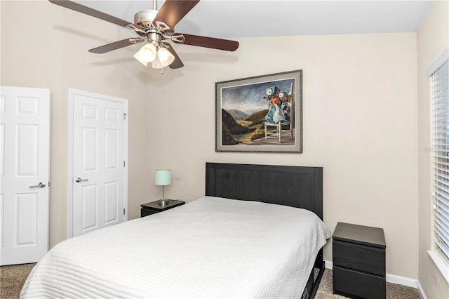 carpeted bedroom with vaulted ceiling and ceiling fan