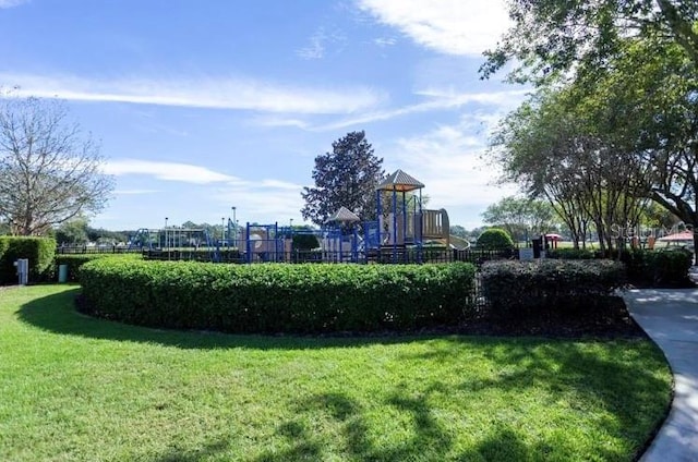 view of property's community with a playground and a yard