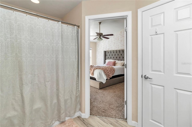 bathroom featuring hardwood / wood-style flooring and ceiling fan