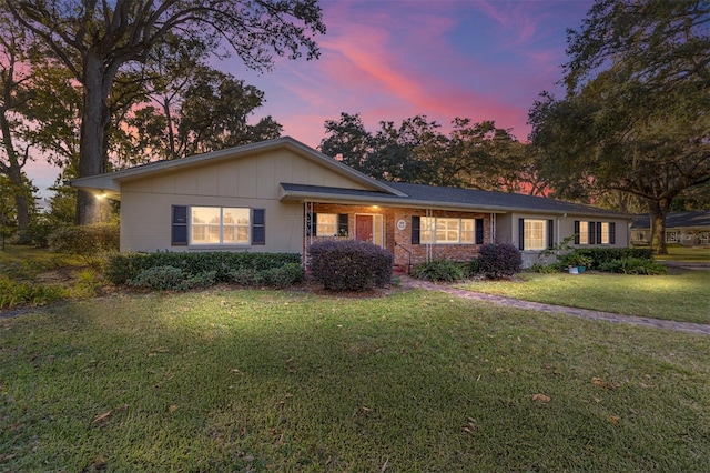 single story home with a lawn