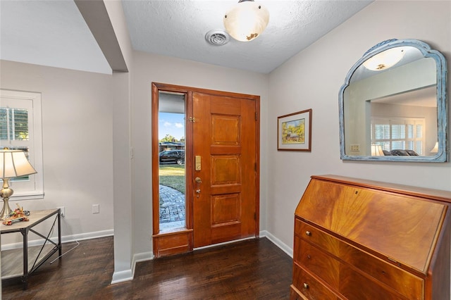 entryway featuring a textured ceiling and dark hardwood / wood-style floors