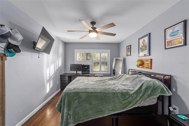 bedroom with dark hardwood / wood-style floors and ceiling fan