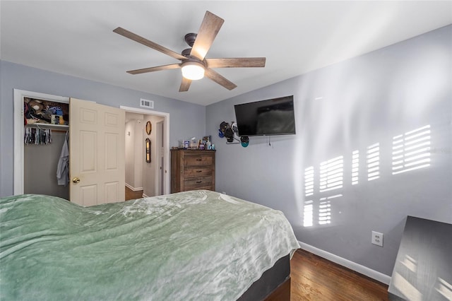 bedroom with a closet, dark hardwood / wood-style floors, and ceiling fan